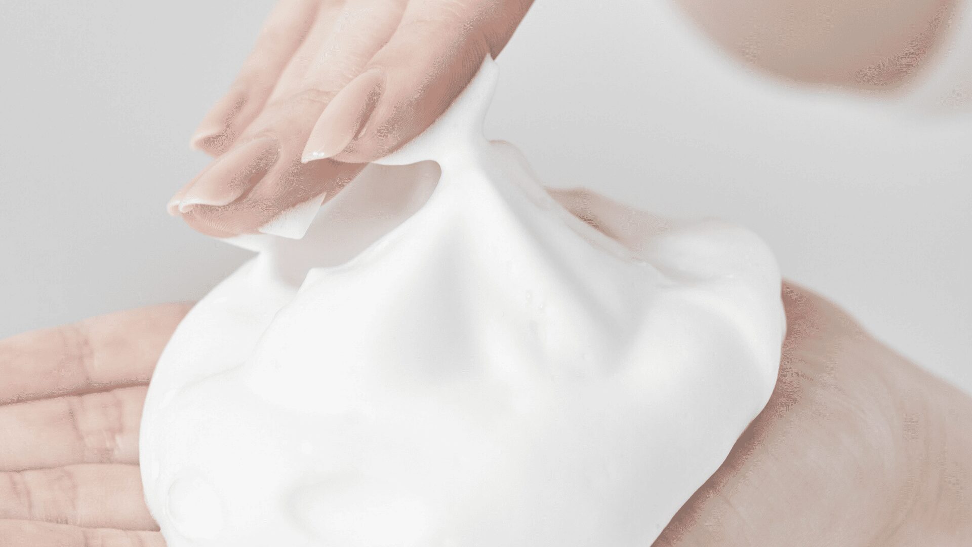 VIEOTY製品のハーモニーウォッシュの豊かな泡となめらかな質感を、心地よさそうな表情で体験しているお客様